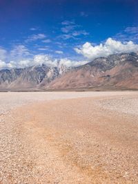 the desert has no animals and is full of dirt and stones, some clouds and snow