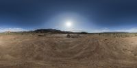 there is a picture of a person on a bike in the desert, in this image, as shown in a fish - eye lens lens view