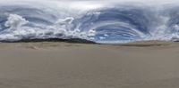 the time lapse view of an unpaved beach with clouds moving in a circle