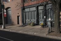 an old building with two trees on the side of it and a fire hydrant in the front yard