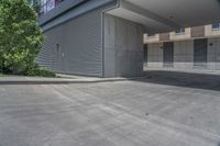 empty parking lot with concrete columns and windows on the roof in front of a skyscraper building