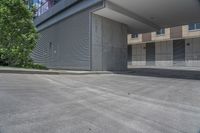 empty parking lot with concrete columns and windows on the roof in front of a skyscraper building