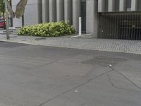 the street in front of the building has been paved with some watermarks and signs