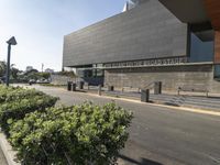 a grey concrete building with a sign that says greater discovery center on it's side