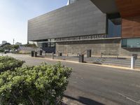 a grey concrete building with a sign that says greater discovery center on it's side