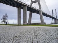 the walkway is made out of concrete and has a walkway on one side, with walkway at the other