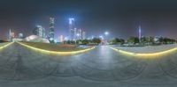 a circular shot of the city skyline at night time with bright lights in it that are reflecting