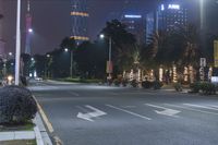 a city intersection at night with traffic lights and a couple people on motorcycles going to work