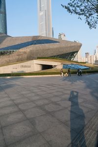 a stone building has a modern style architecture in it's centerpiece, as seen from the plaza