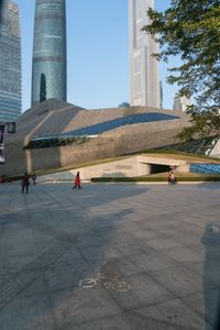 a stone building has a modern style architecture in it's centerpiece, as seen from the plaza