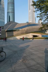 a stone building has a modern style architecture in it's centerpiece, as seen from the plaza