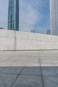 a man riding on top of a skateboard next to tall buildings filled with tall skyscrapers