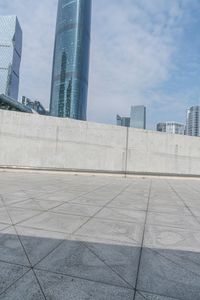 a man riding on top of a skateboard next to tall buildings filled with tall skyscrapers