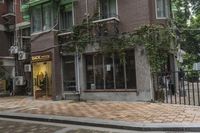 there is a bike on the sidewalk outside of the shopfront building that reads rick's