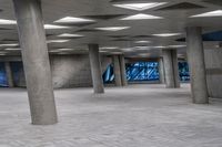 there is an empty open space with concrete columns, and many square tiles on the ground