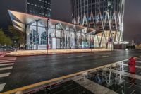 the large glass building in front of the red fire hydrant has been built into the side