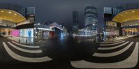 street scene with buildings in the night and city lights on the road and buildings in the background