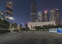 a road near a large city at night with several skyscrapers behind it and a sign that says the global conference on it