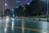 a city street with buildings and neon lights at night time in hong china as seen from an empty city highway