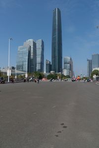 the street that runs between two large skyscrapers in a city with no cars on it