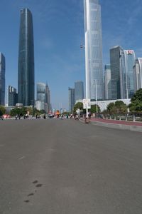 the street that runs between two large skyscrapers in a city with no cars on it