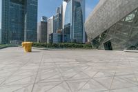 yellow fire hydrant in front of large, modern buildings and walkway in front of skyscrapers