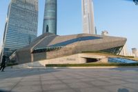 a stone building has a modern style architecture in it's centerpiece, as seen from the plaza