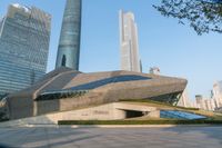 a stone building has a modern style architecture in it's centerpiece, as seen from the plaza