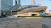 a stone building has a modern style architecture in it's centerpiece, as seen from the plaza