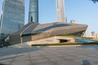 a stone building has a modern style architecture in it's centerpiece, as seen from the plaza