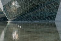 an image of a very interesting building reflected in the water of it's pond