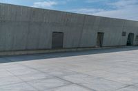 a person doing a skateboard trick in a large concrete building complex of a park