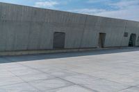 a person doing a skateboard trick in a large concrete building complex of a park