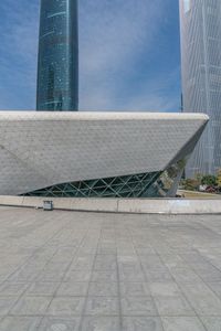 large building with two tall buildings sitting next to each other, in front of some buildings