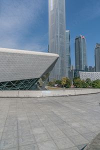 large building with two tall buildings sitting next to each other, in front of some buildings