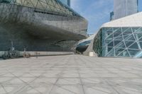 there is a bench that is on the sidewalk outside of the building, which is also the entrance to the convention center