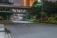 a city street with buildings and neon lights at night time in hong china as seen from an empty city highway