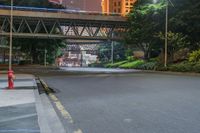 a city street with buildings and neon lights at night time in hong china as seen from an empty city highway