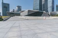 a woman on a skateboard in a big city square of the day and looking at some buildings