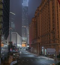 a city street with buildings and neon lights at night time in hong china as seen from an empty city highway