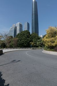 the young man is riding his bicycle near tall buildings in a cityscape area