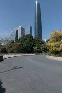 the young man is riding his bicycle near tall buildings in a cityscape area