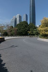 the young man is riding his bicycle near tall buildings in a cityscape area