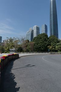 the young man is riding his bicycle near tall buildings in a cityscape area