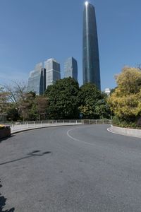 the young man is riding his bicycle near tall buildings in a cityscape area