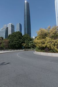 the young man is riding his bicycle near tall buildings in a cityscape area