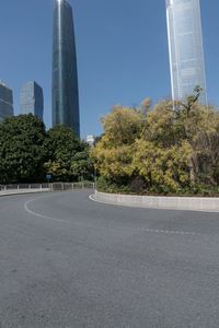 the young man is riding his bicycle near tall buildings in a cityscape area