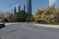 the curved road is in front of some high buildings in a city area with no people