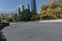 the curved road is in front of some high buildings in a city area with no people