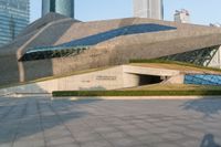 a stone building has a modern style architecture in it's centerpiece, as seen from the plaza